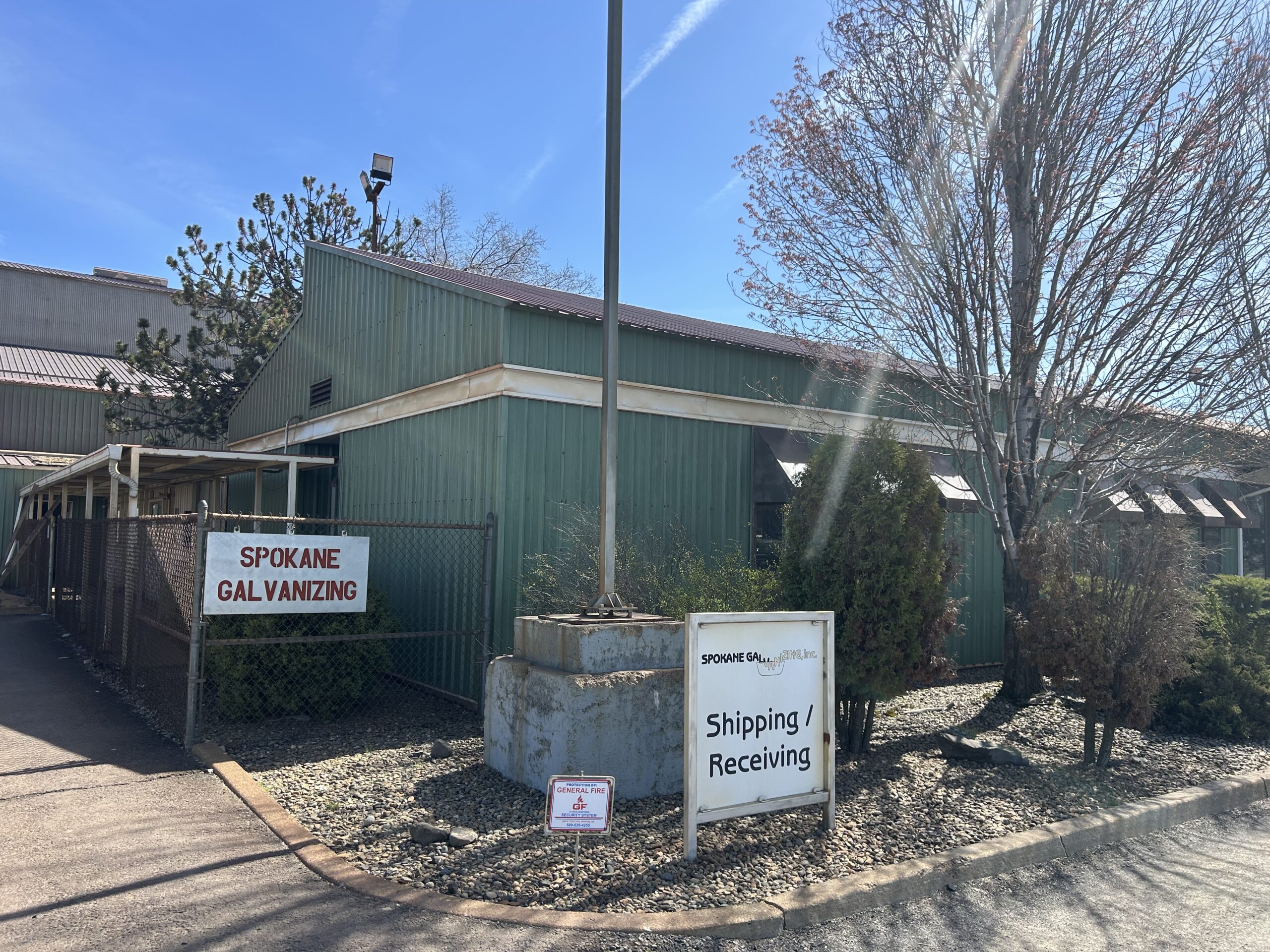 IMG_1122 Vintage photo of a small white and red boat on an early EZ Loader trailer in front of a workshop.