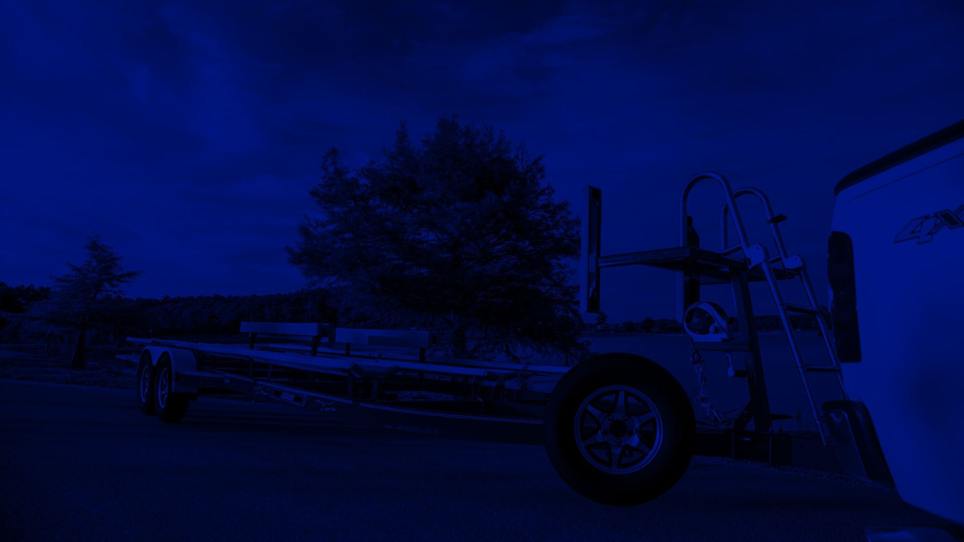 Single axle aluminum trailer with diamond plate fender and galvanized steel wheel for durable boat hauling.