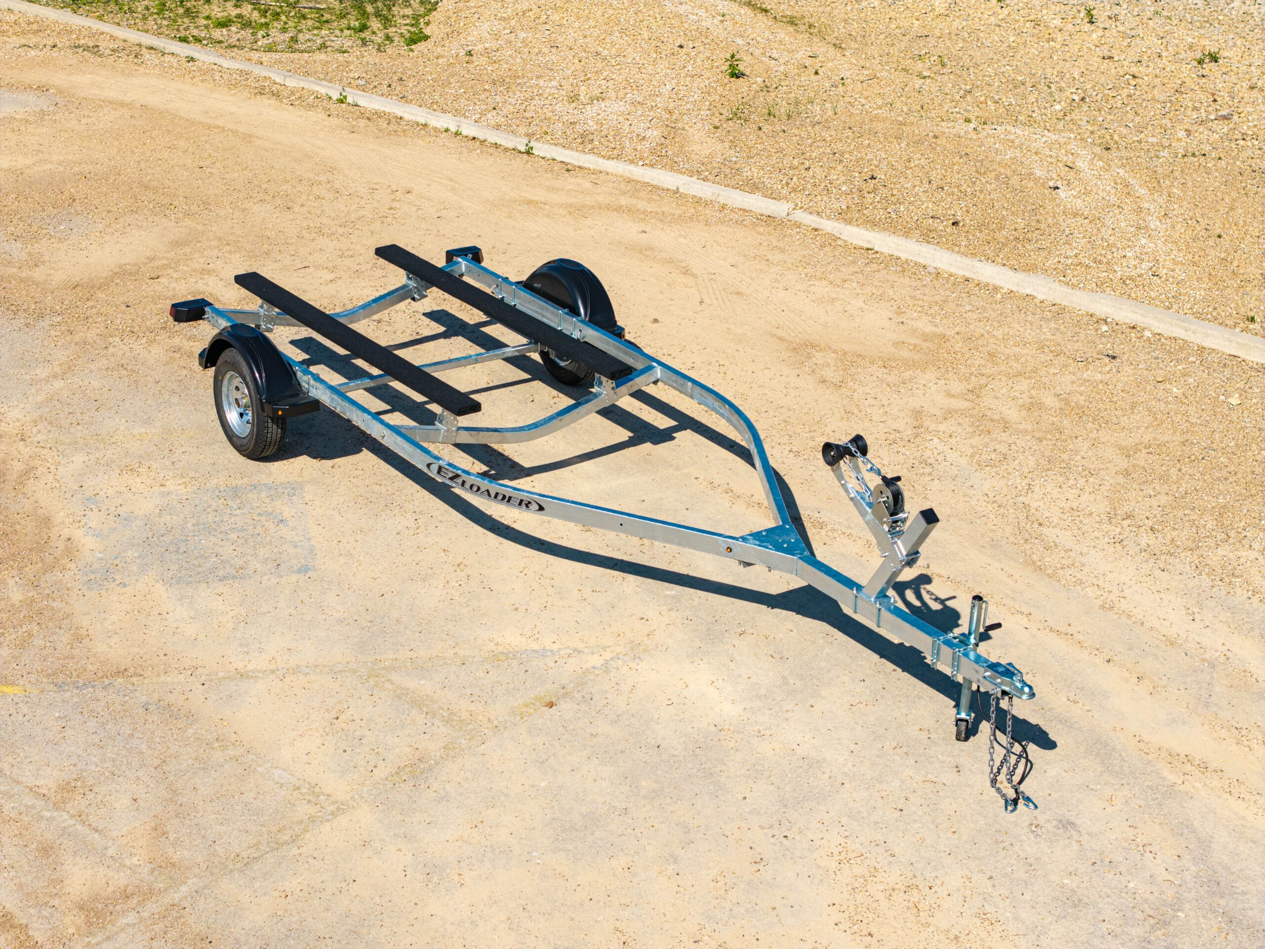 Single axle EZ Loader boat trailer with galvanized frame, bunk supports, and winch post with bow roller.