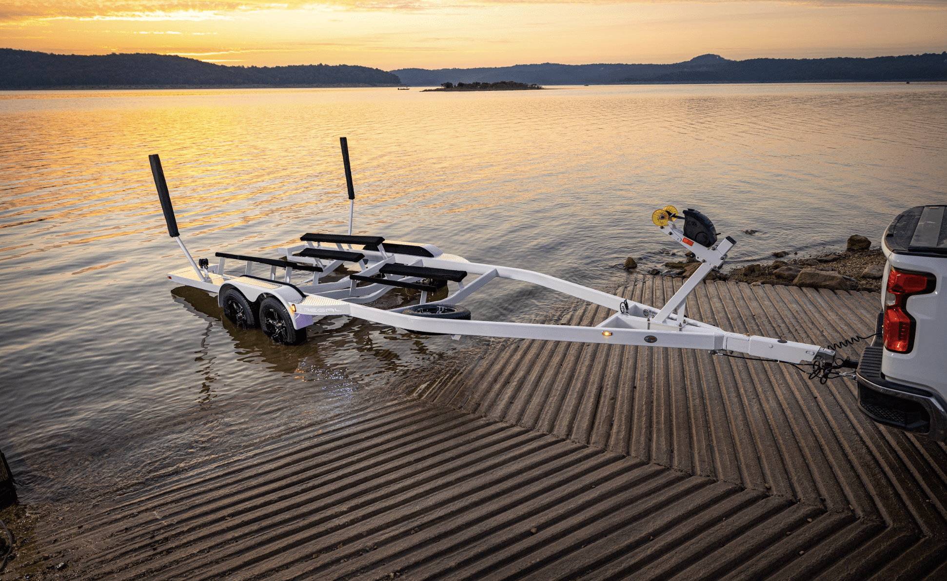 EZ Loader custom single axle steel pontoon trailer featuring black powder-coated frame, winch stand with load guides, and dual bunk system designed for secure and stable pontoon boat transport.