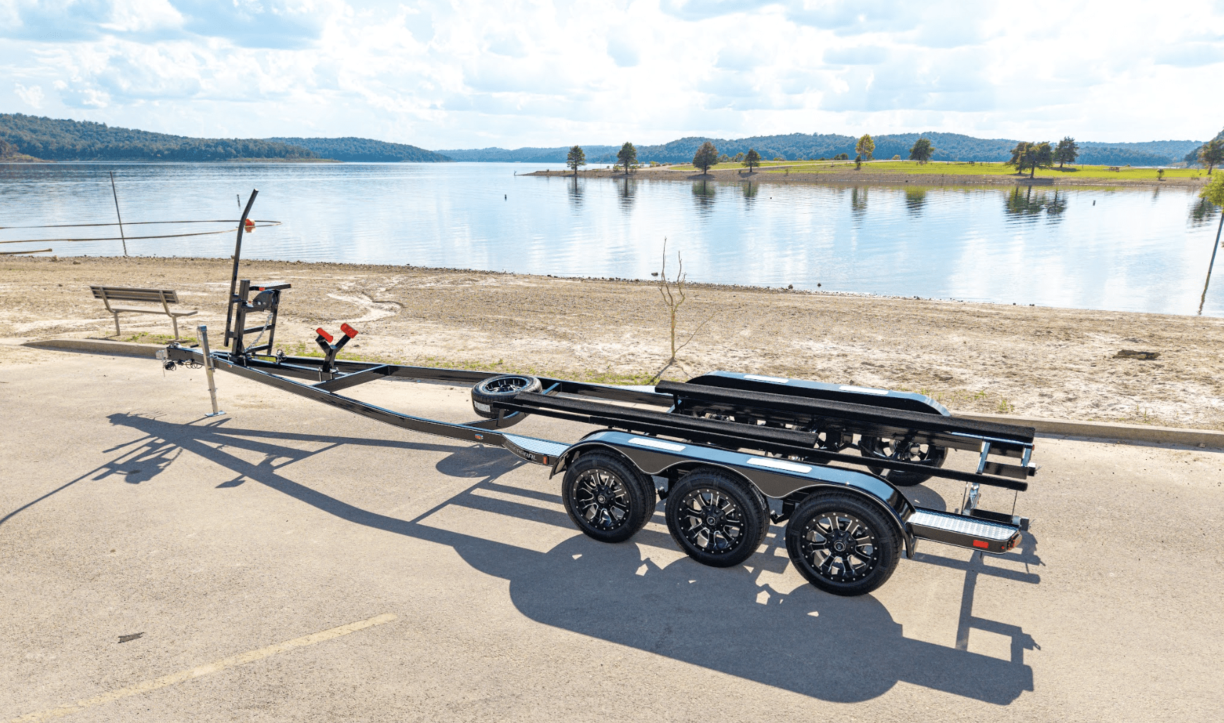 EZ Loader custom tandem axle aluminum pontoon trailer with integrated boarding ladder, marine-grade bunks, and corrosion-resistant frame built for lightweight, long-lasting performance.