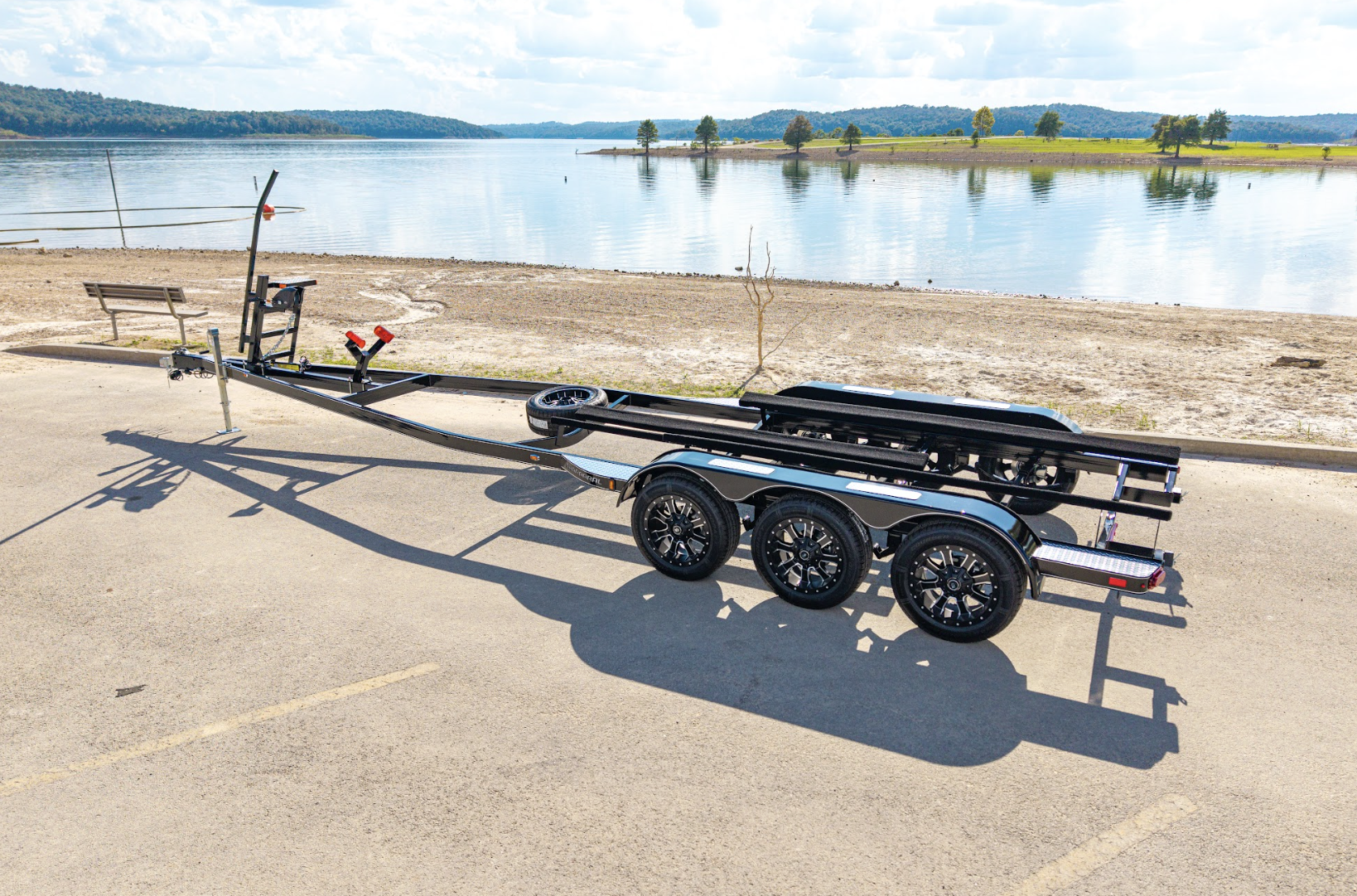 EZ Loader custom tandem axle aluminum pontoon trailer with integrated boarding ladder, marine-grade bunks, and corrosion-resistant frame built for lightweight, long-lasting performance.